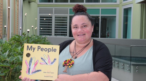 My People book held up by author Billie-Jean Taylor