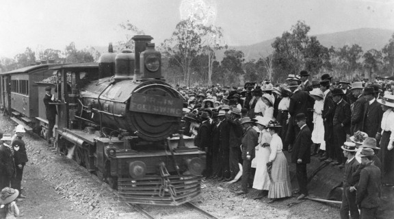 People assemble in front of the locomotive on the opening day