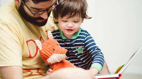 Father reading to their child and sparking conversation