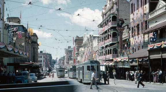 View along Adelaide Street from George Street with the buildings decorated for the Royal Visit, 1954