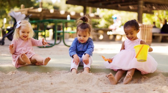 Kids playing outside in sand pit