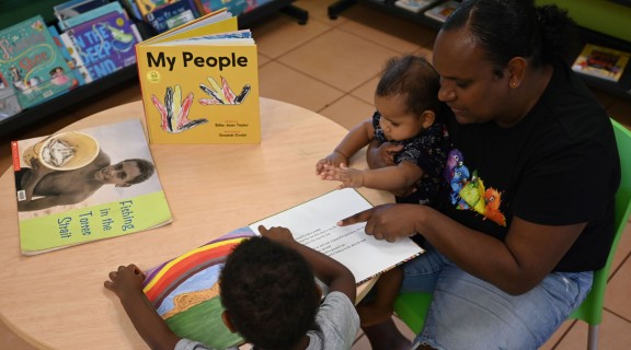 Adult and children reading 