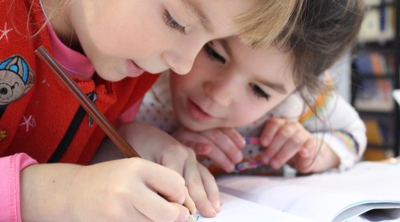 Two young girls drawing