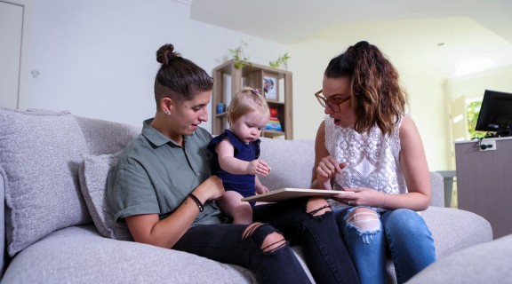 Parents and baby playing inside