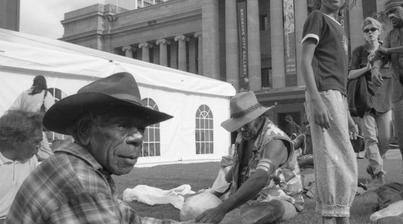 Attendees sitting on the grass at King George Square enjoying the DAR Indigenous Art and Culture Festival