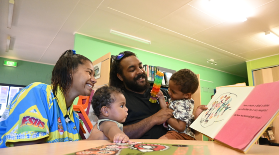 A First Nations family read together at a Indigenous Knowledge Centre