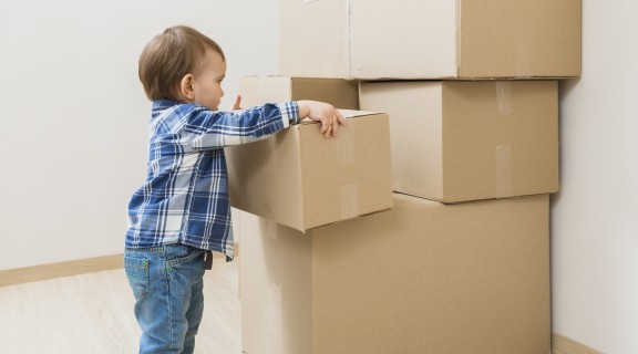 Toddler playing with boxes