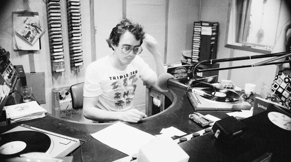 A photo of a 4ZZZ radio announcer in the studio
