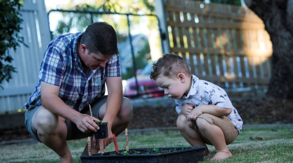 Father and son tending to garden together