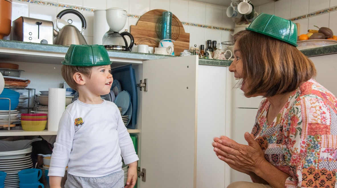 Woman playing with a child in the kitchen