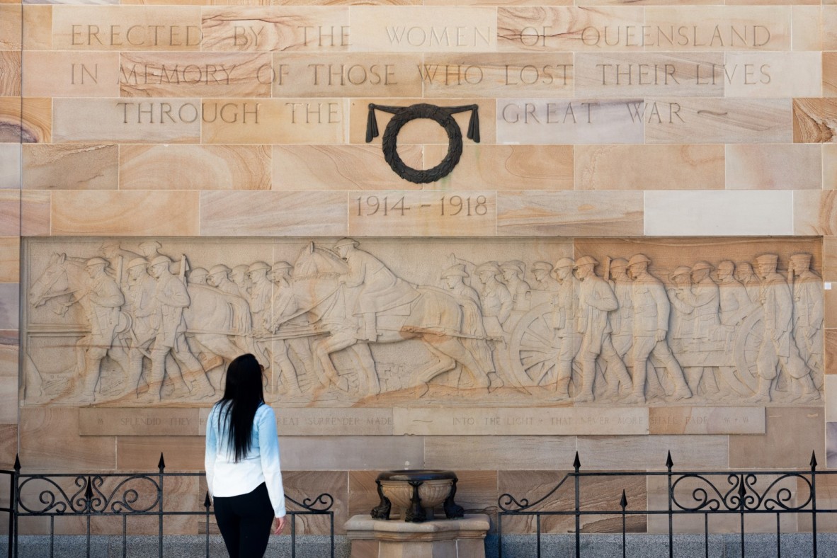 Photo of a person standing in front of the Womens Memorial at Anzac Square