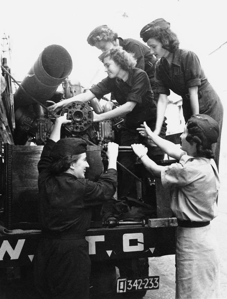 5 members of the Womens Auxiliary Transport Corps around the back of a truck with salvage metal 1942