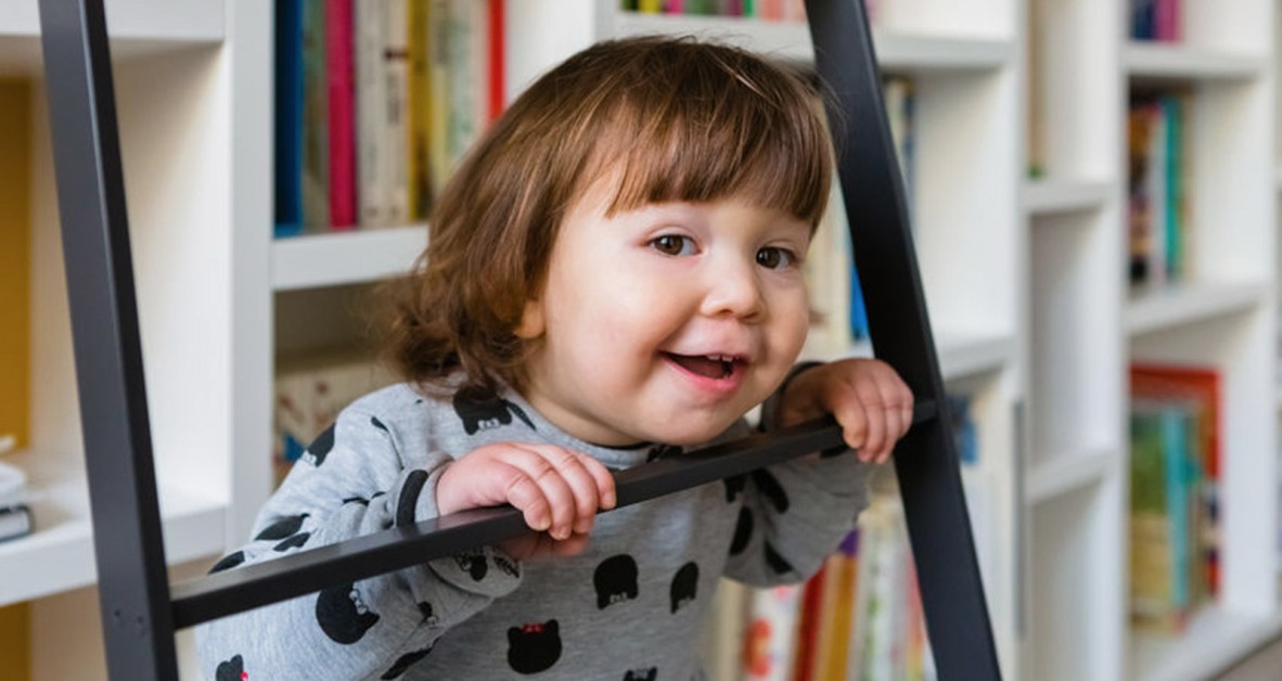 Child at the library in front of books