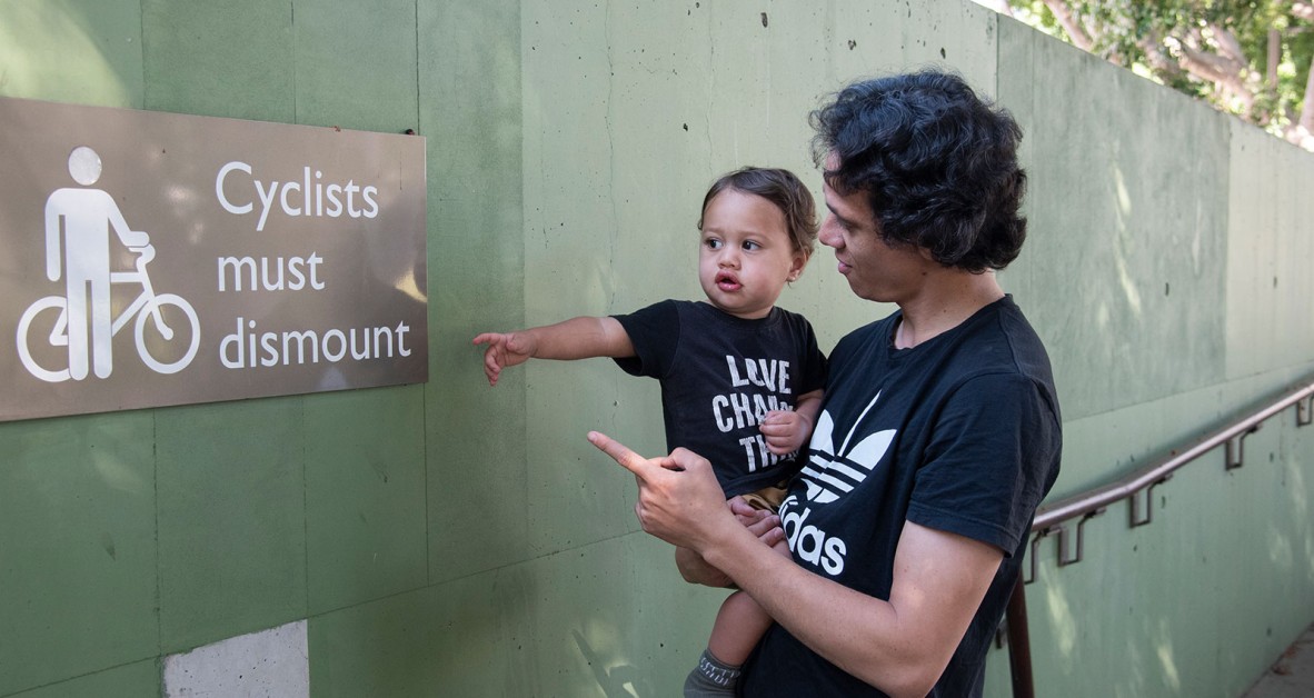 Woman and child pointing at a sign