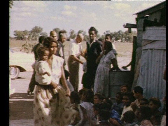 Grandma Joan West with her baby, at church in Goodooga Tin Camp in 1962.