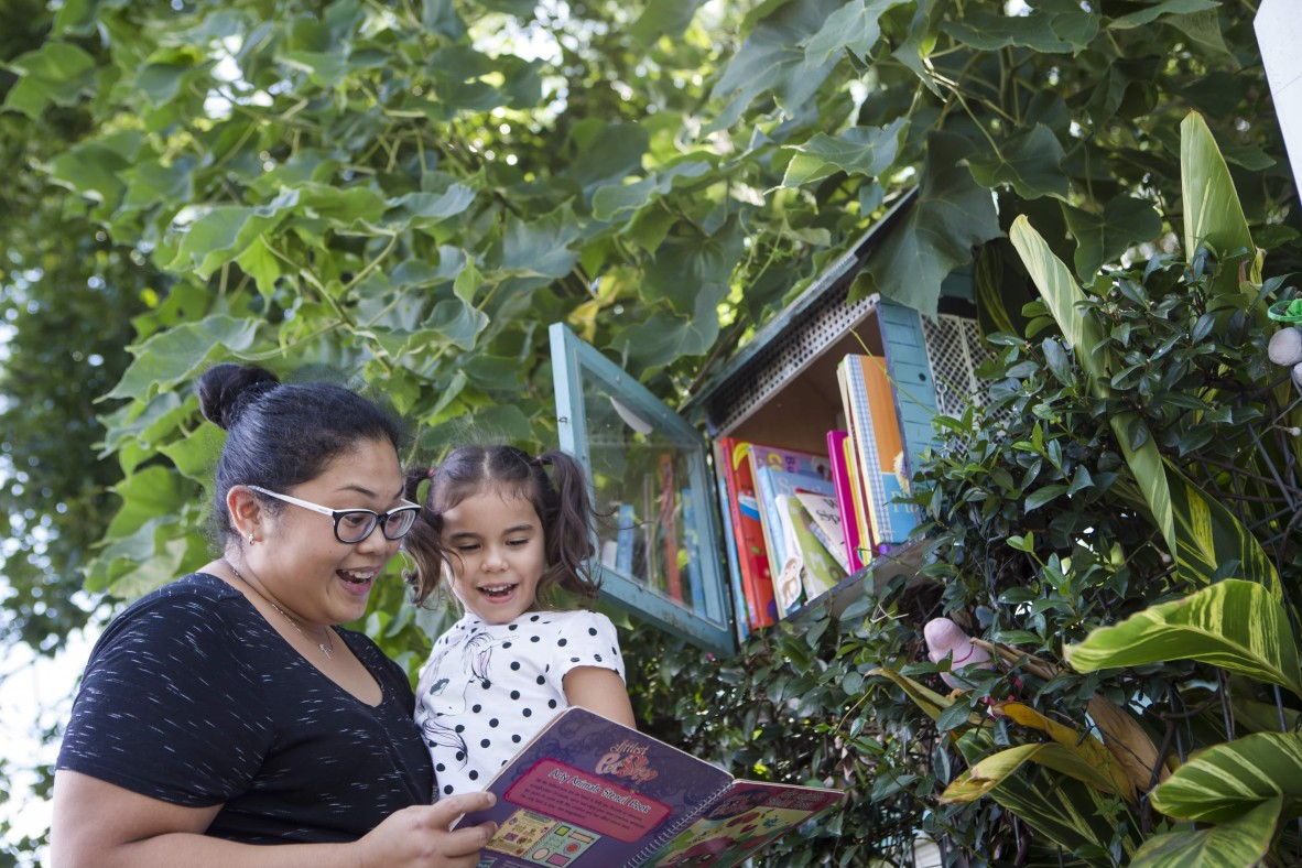 Mother and daughter selecting a book 