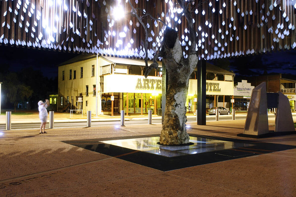 Colour photograph of Barcaldine's Tree of Knowledge Memorial at night
