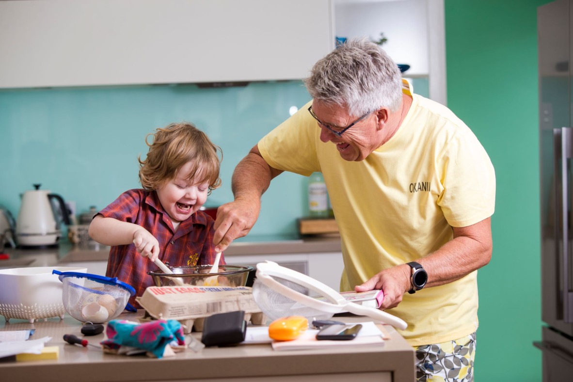 Toddler and grandfather cooking together
