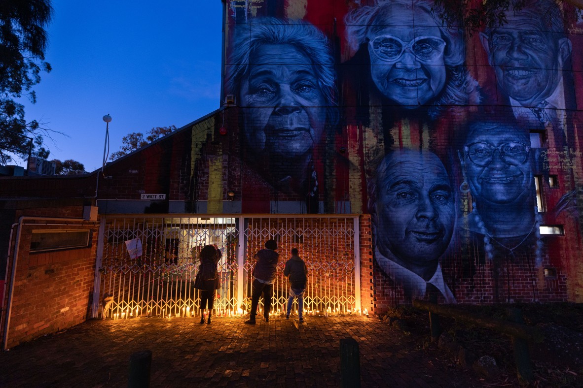 A photo of people gathered at a candle-lit vigil 