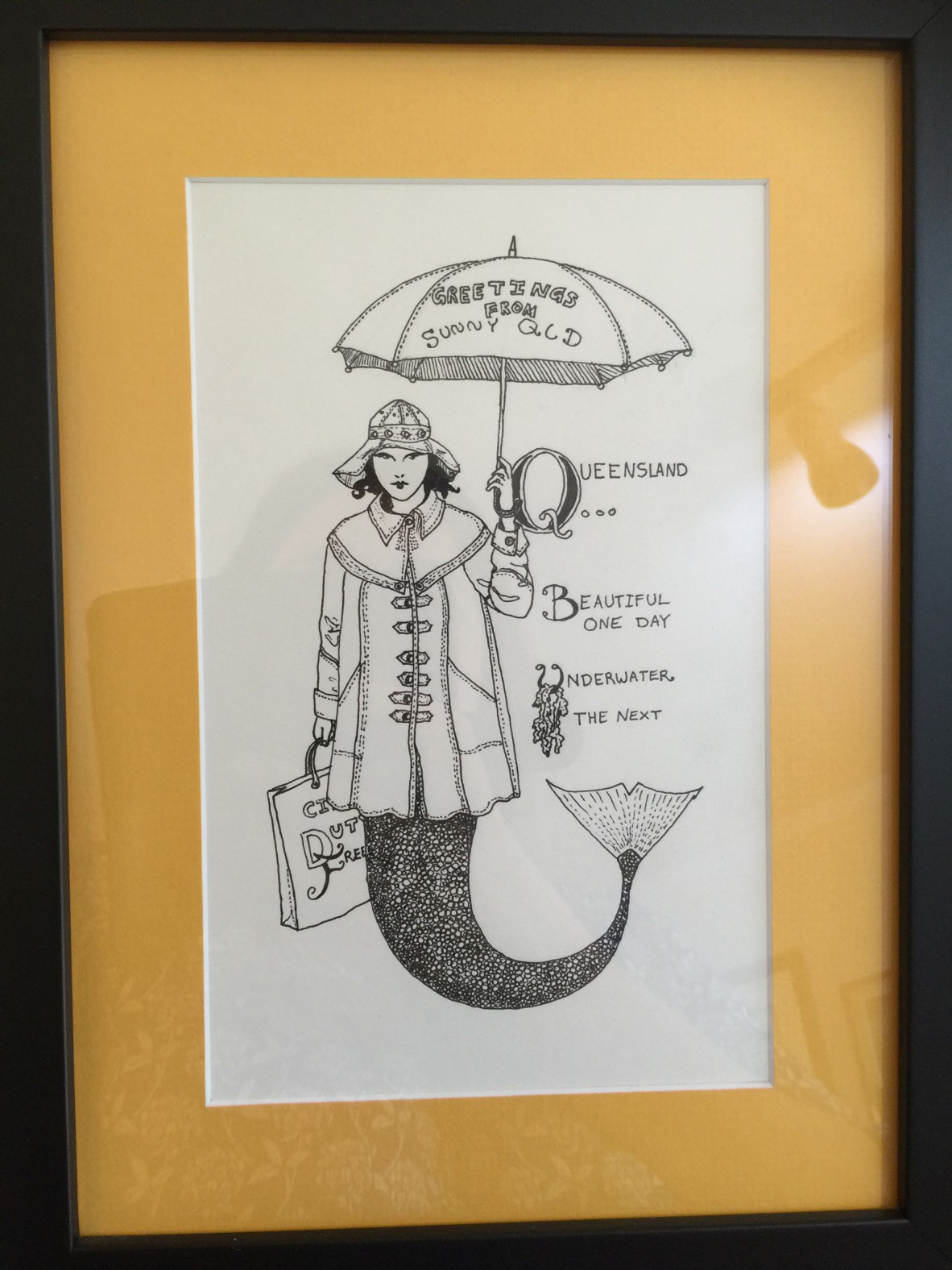 An illustration of a mermaid holding an umbrella. It's captioned, "Queensland... Beautiful one day, underwater the next."