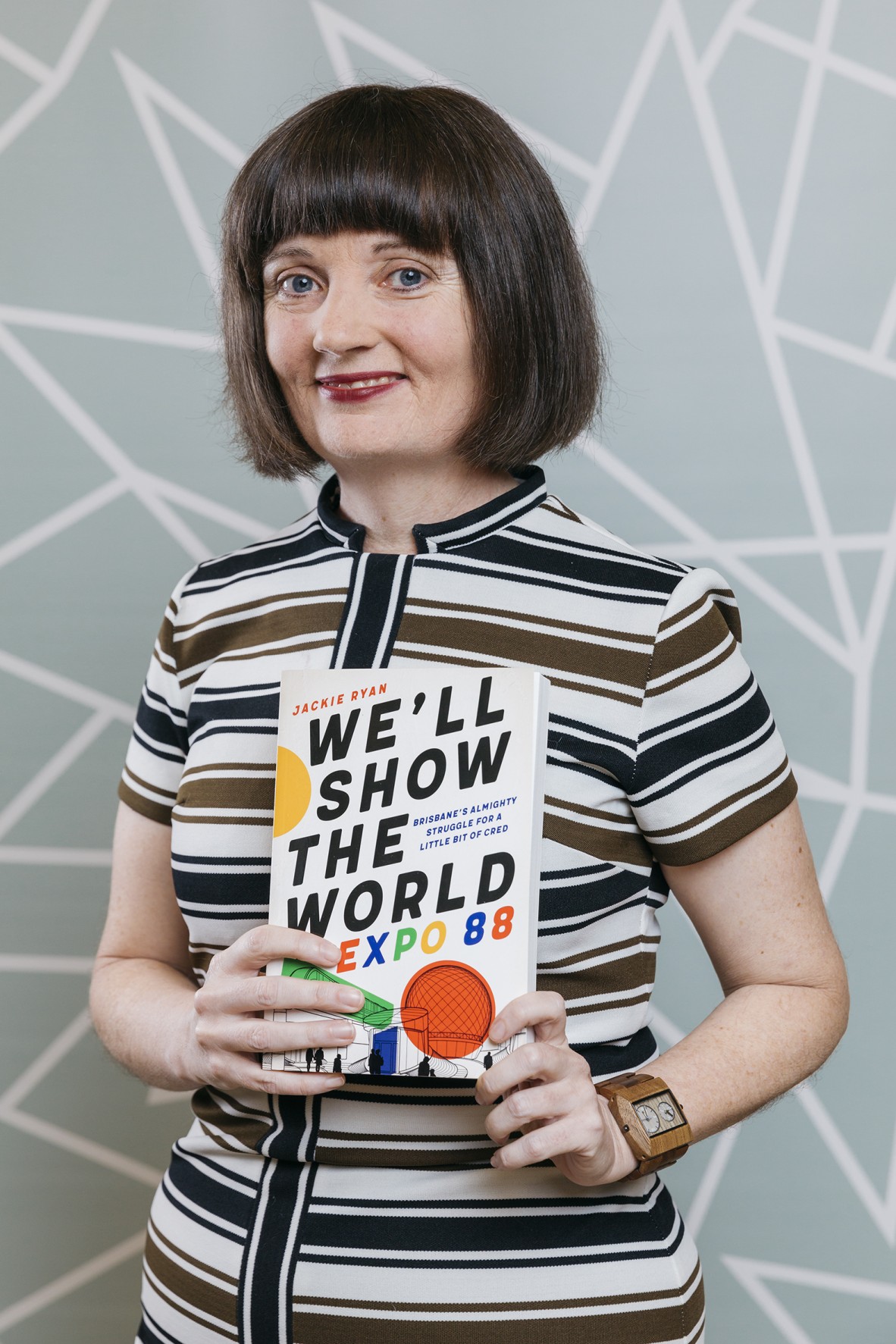 Jackie Ryan holding her book 'We'll Show the World: Expo 88'