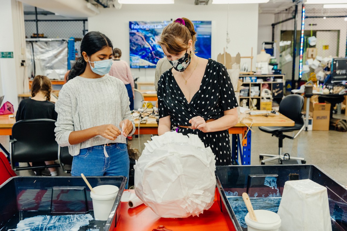 Facilitator and young person working on a lantern