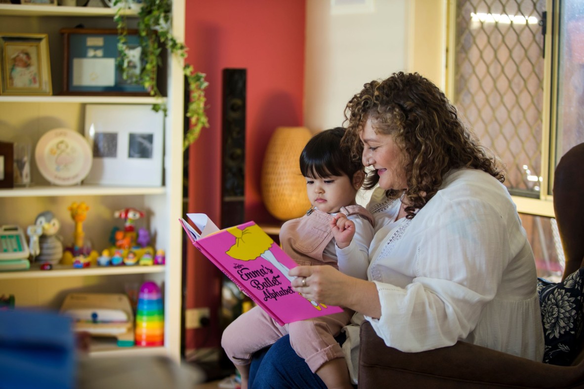 Mother and child reading a book about ballet