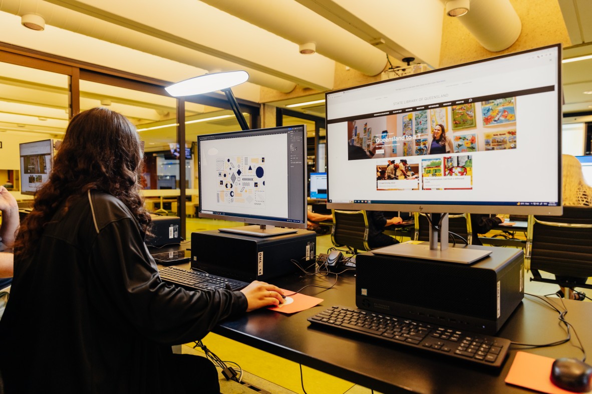 Young woman working on computer using image software to create Vector design