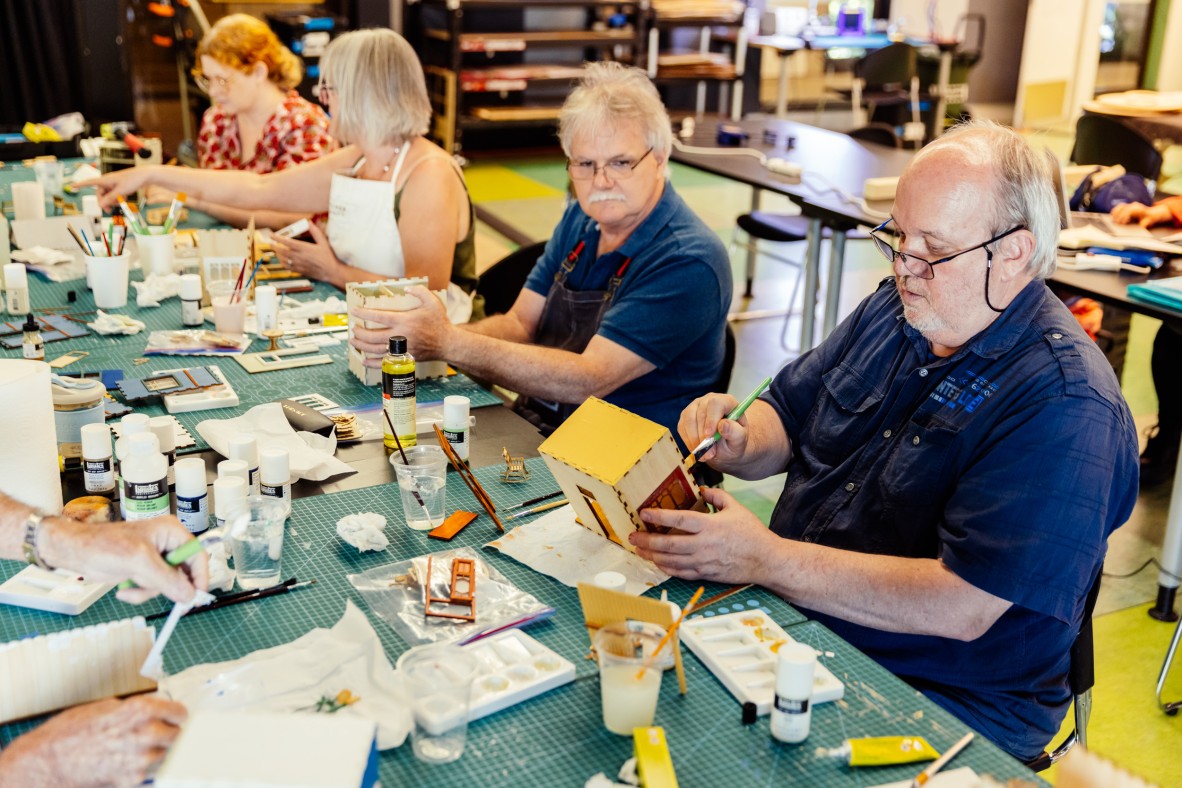 Photo of people making Queensland architecture in miniature