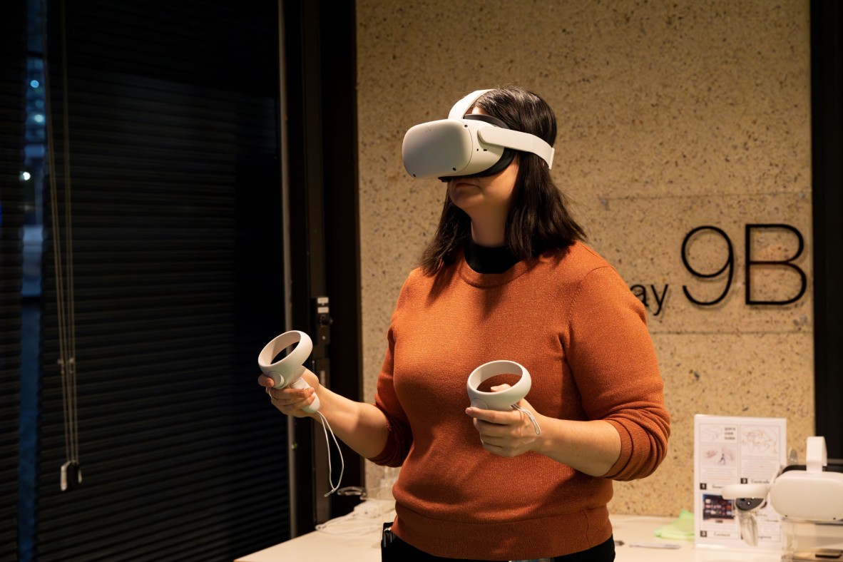 person with VR headset uses virtual reality