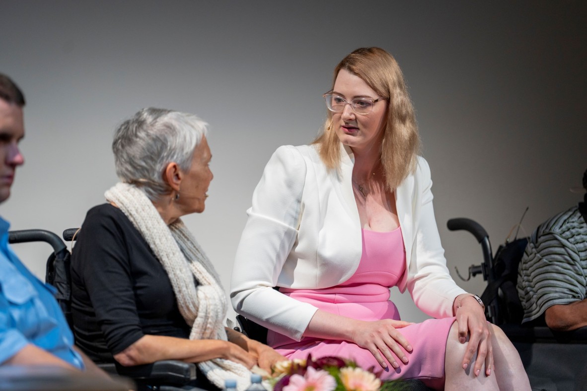 two women in wheelchairs chat