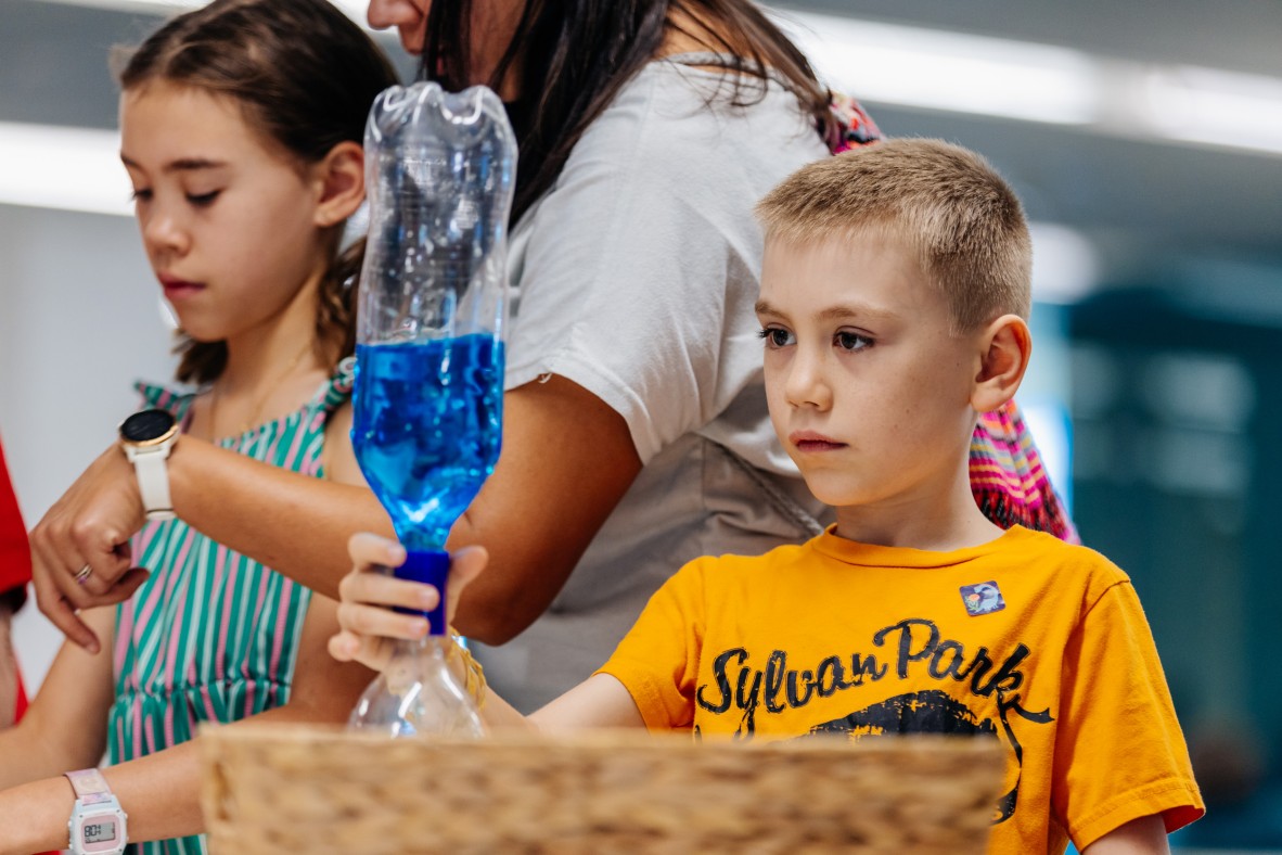 Two kids playing with bottles
