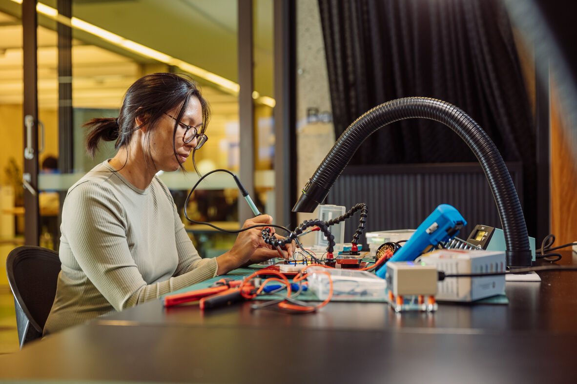 A photo of someone soldering electronics