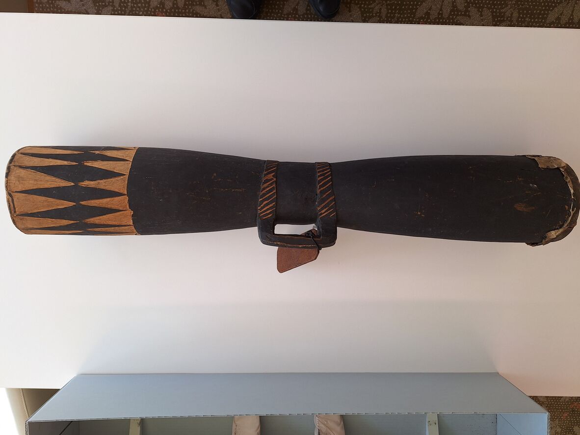 Carved wooden drum with reptile skin membrane