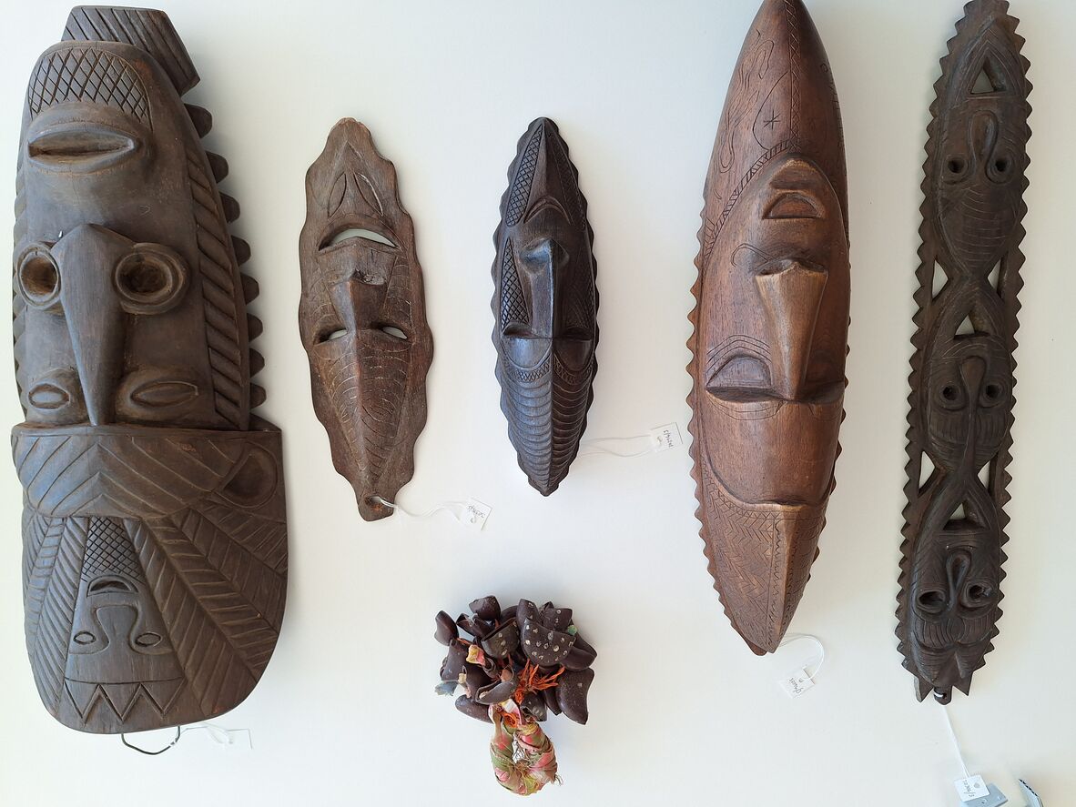 Five wooden face carving and a dance rattle (kulap)