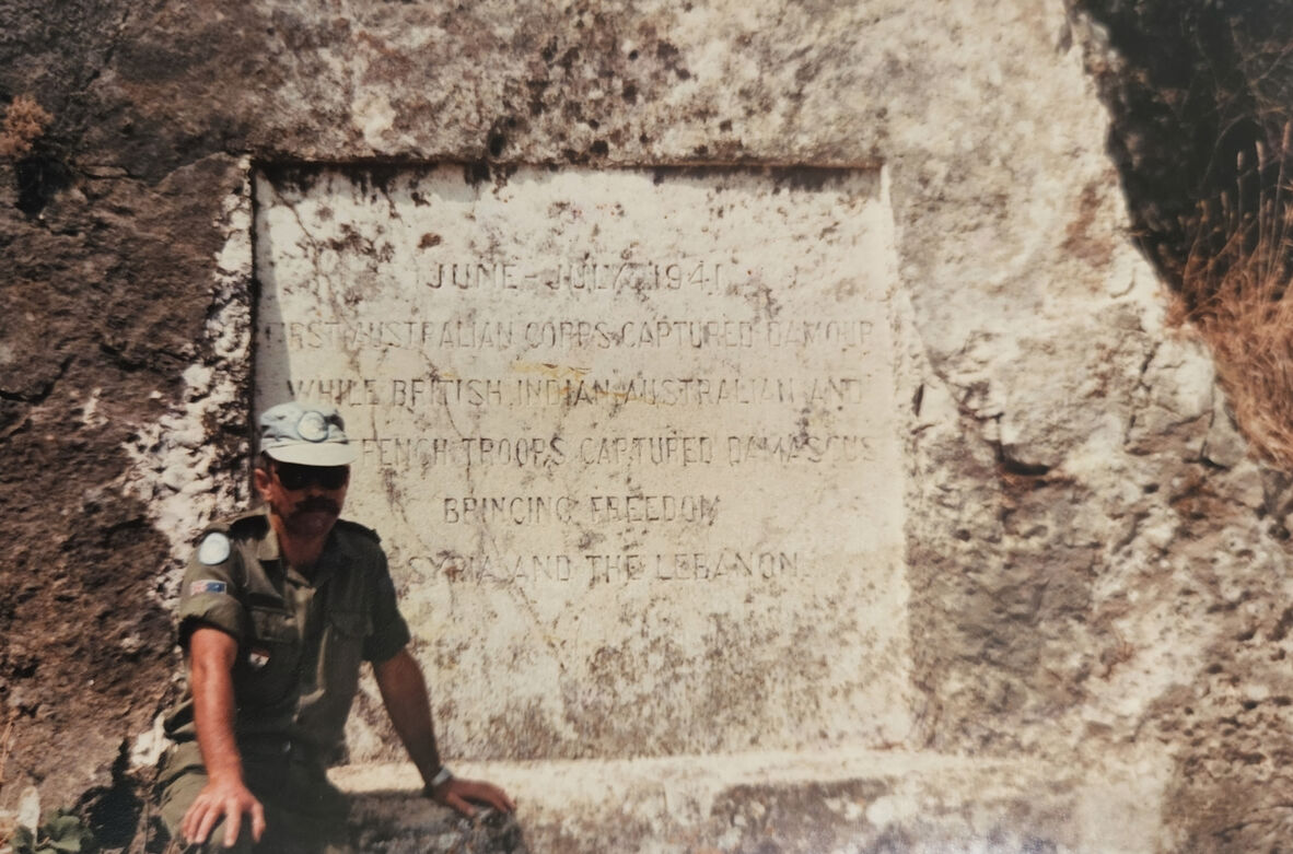 Joe Cazey beside Battle of Damour memorial