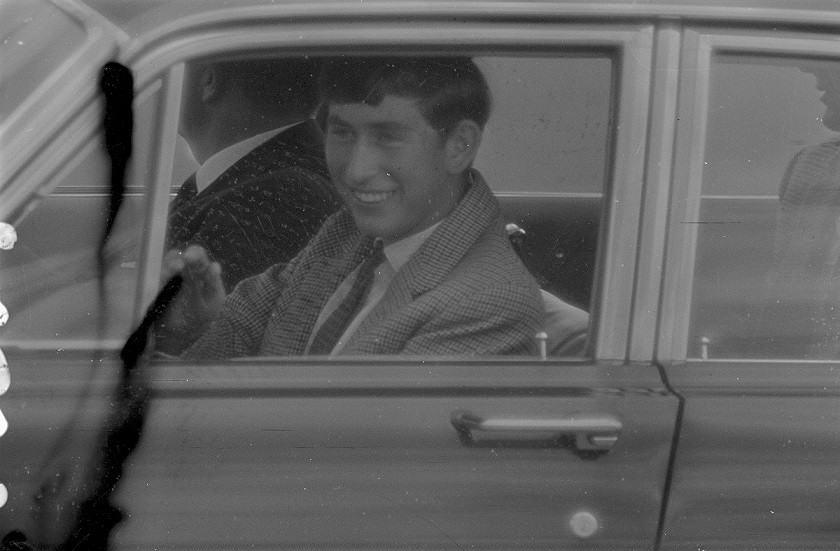Prince Charles in a car waving at Brisbane Airport, May 1966