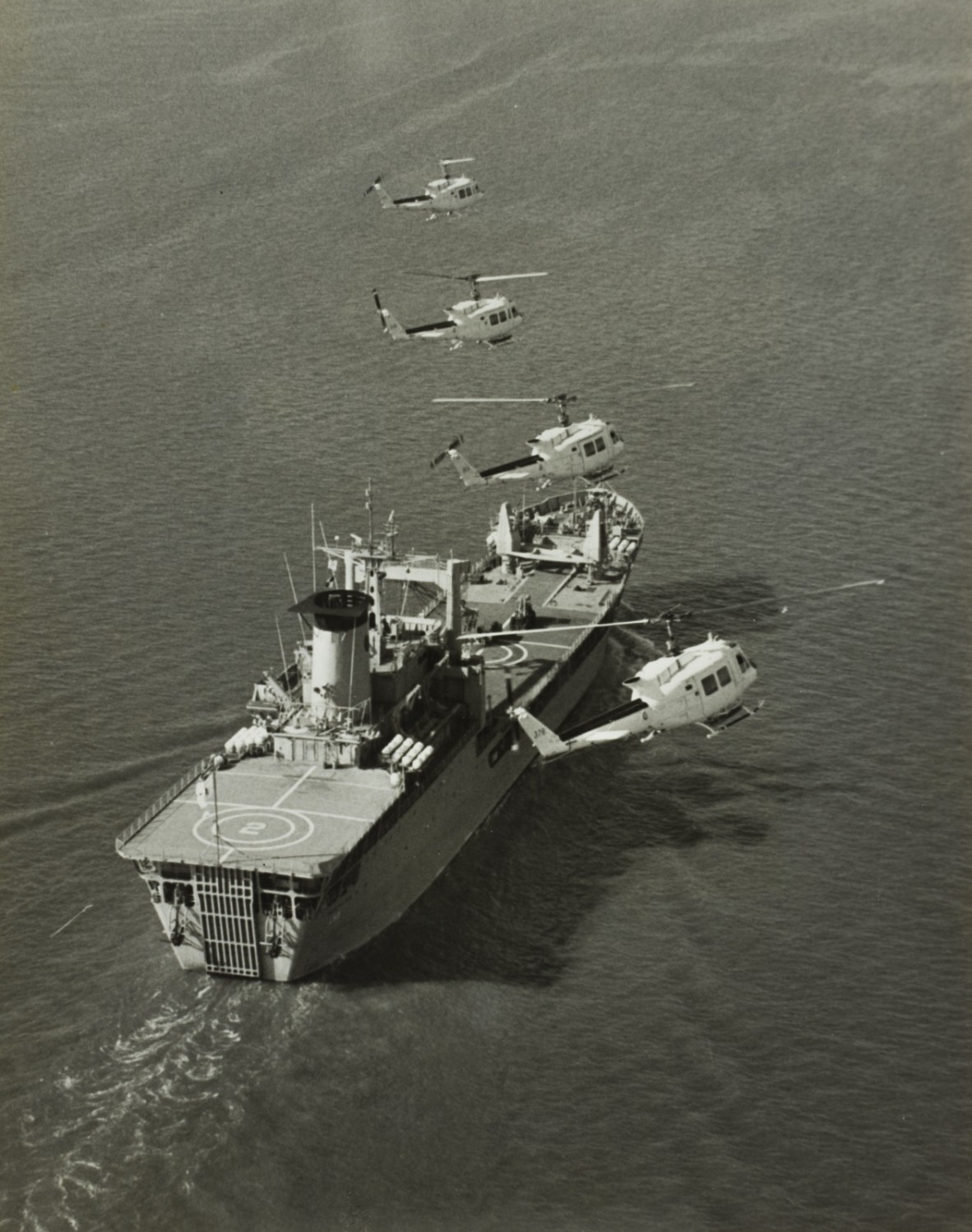  RAAF Iroquois helicopters preparing to land on HMAS Tobruk, Moreton Bay, 1982