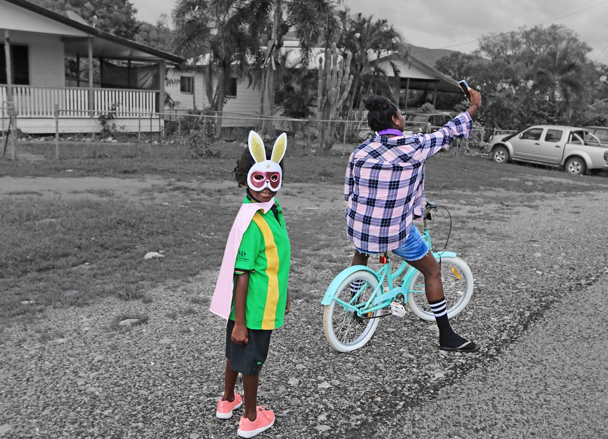 Young girl wearing a bunny mask and her mum taking a selfie outside