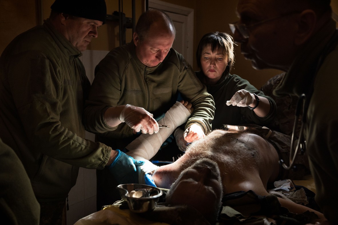 A photo of doctors working on an injured man 