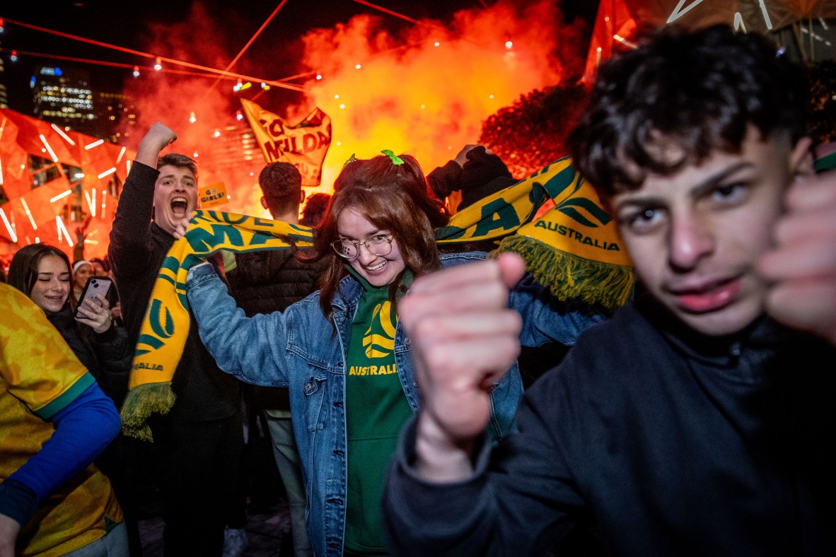 A photo of football fans celebrating at Federation Square