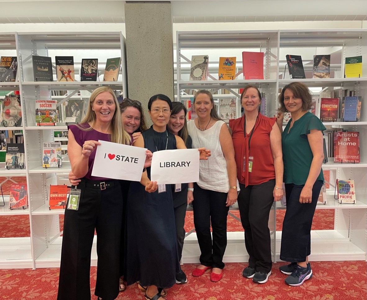 Group of staff members holding an I love State Library sign