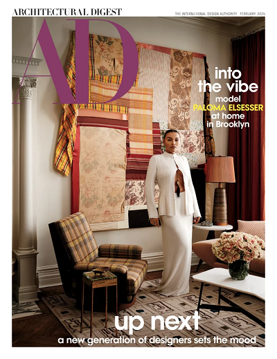 Woman in white outfit standing in a living room on cover of Architectural Design magazine