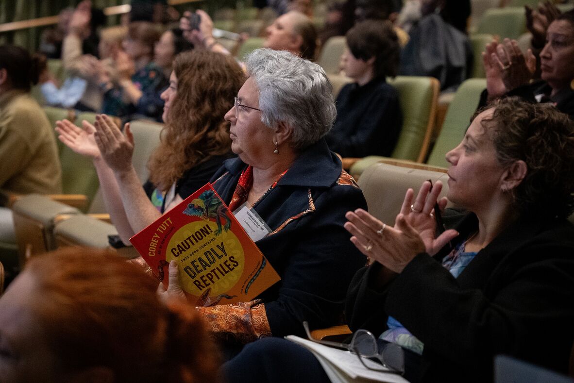 Audience member of 2026 Indigenous Languages Forum holding Deadly Science book