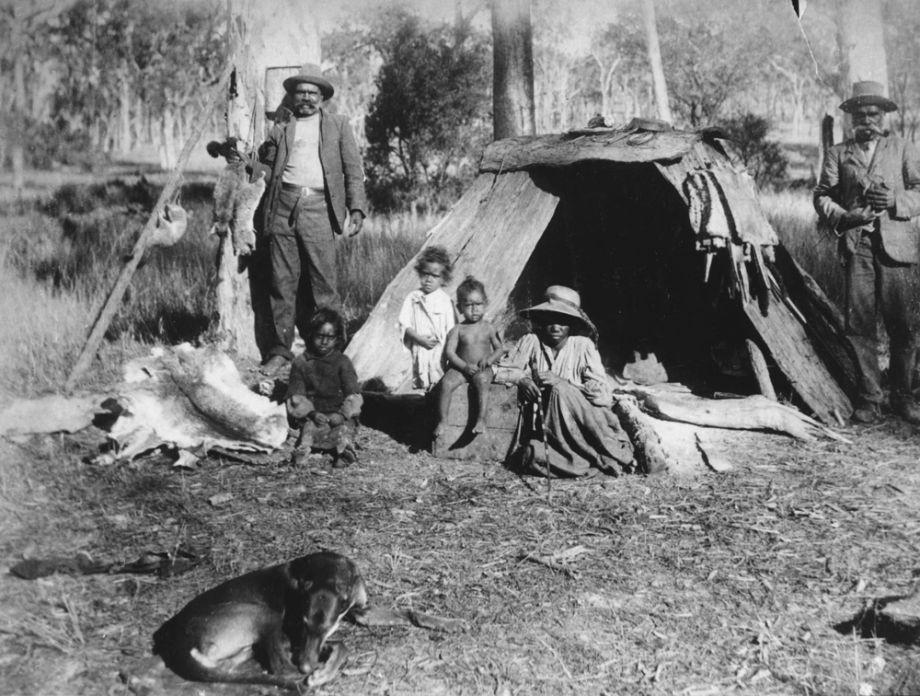 Group of Aboriginal men women and children with animal skins in Ipswich