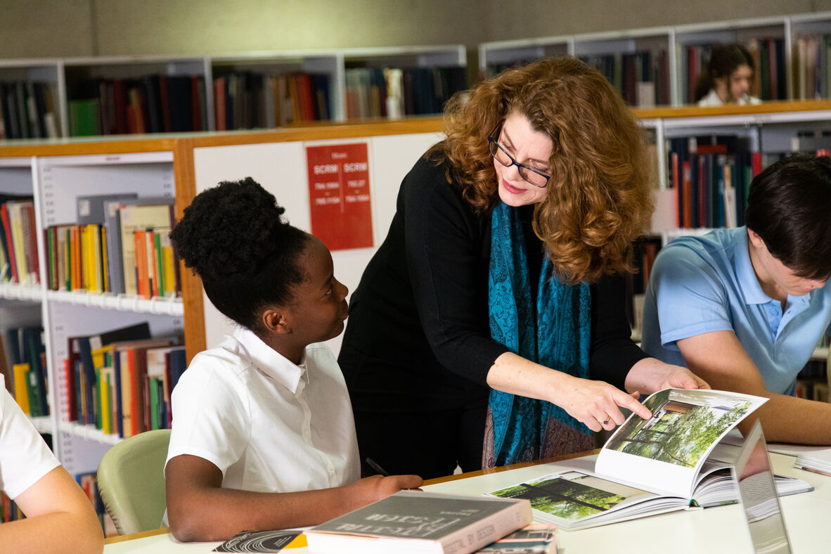 Teacher helping students in the library