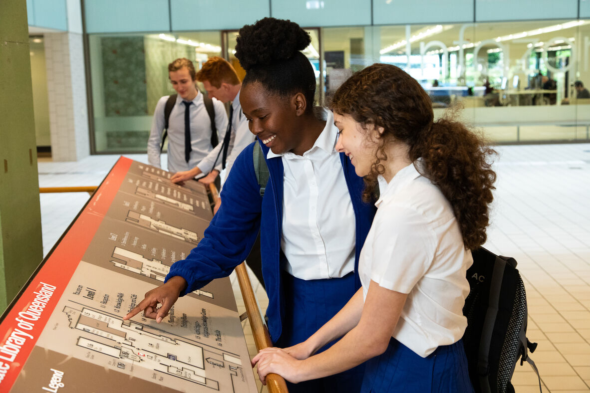 Students looking at State Library of Queensland building map, level 1