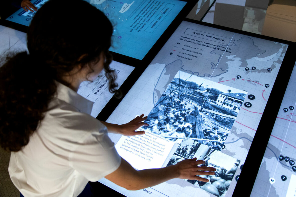 Student using an interative screen to view old photograph.