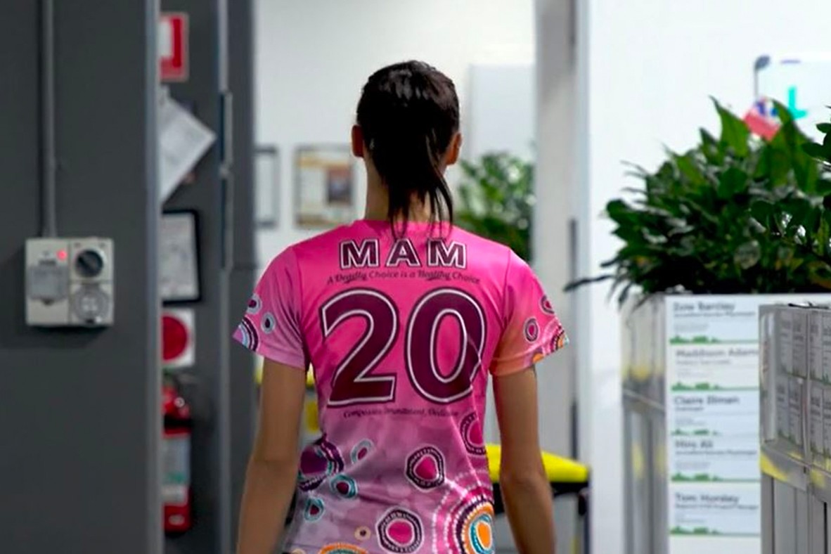 A still from a video showing the back of a person wearing a number 20 Aunt Pam jersey