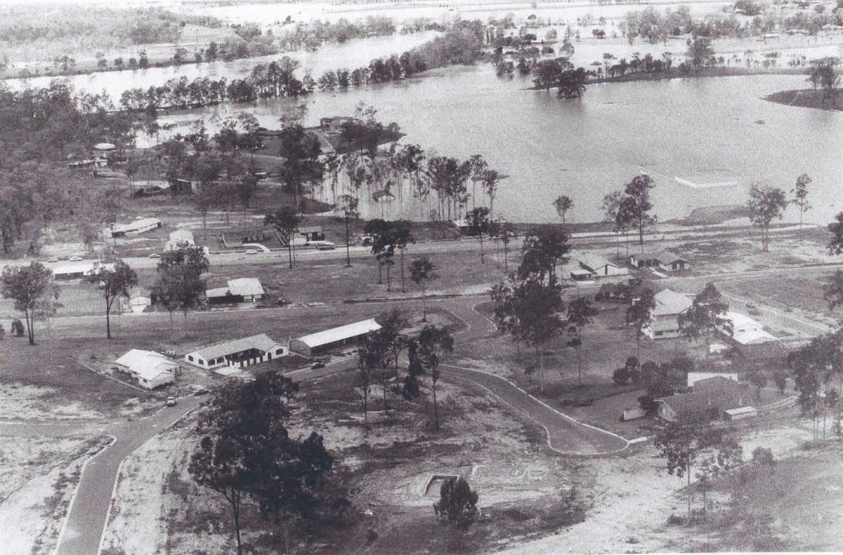 The roof of the newly opened Bellbowrie shopping centre can be seen on the right inundated by floodwaters in January, 1974. Photo: N.A Marsh, courtesy of Moggill Historical Society 